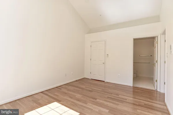 a view of an empty room and wooden floor