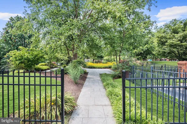 a view of a chair and tables under an umbrella
