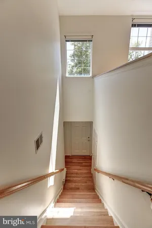 a view of a room with wooden floor and kitchen