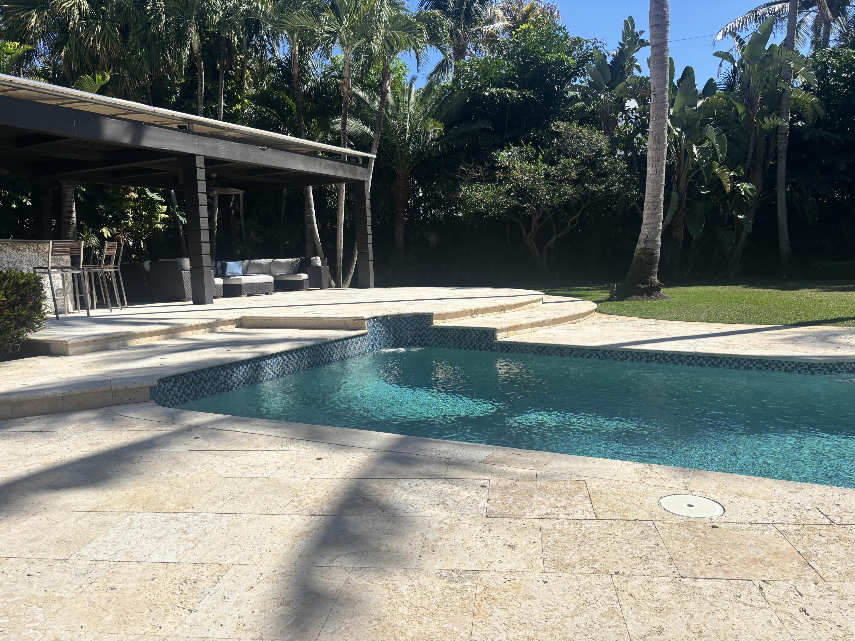 2100 Spanish River Road Boca Raton, FL 33432 - Photo 11 of 38 a view of swimming pool with lawn chairs and plants