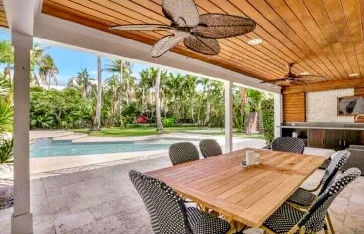 2100 Spanish River Road Boca Raton, FL 33432 - Photo 15 of 38 a view of a patio with a table chairs and a backyard