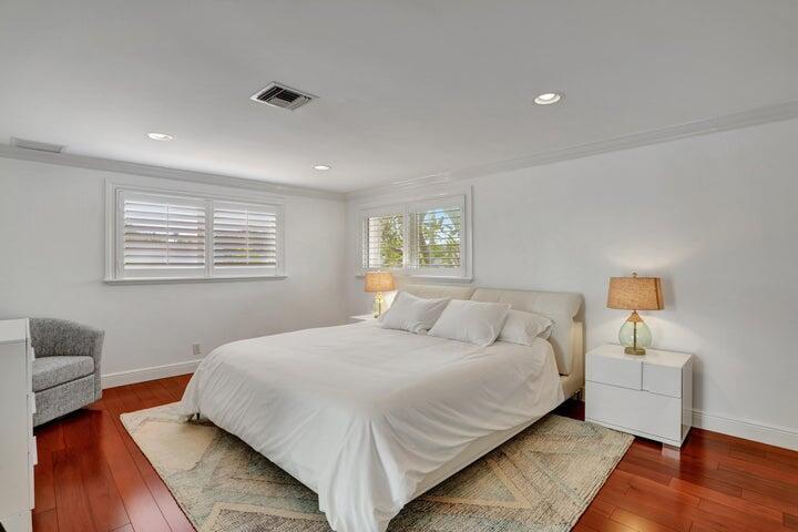 2100 Spanish River Road Boca Raton, FL 33432 - Photo 26 of 38 a bedroom with a bed and wooden floor