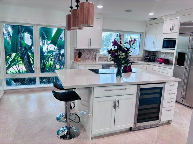 2100 Spanish River Road Boca Raton, FL 33432 - Photo 33 of 38 a kitchen with stainless steel appliances a counter space a sink a refrigerator and a stove