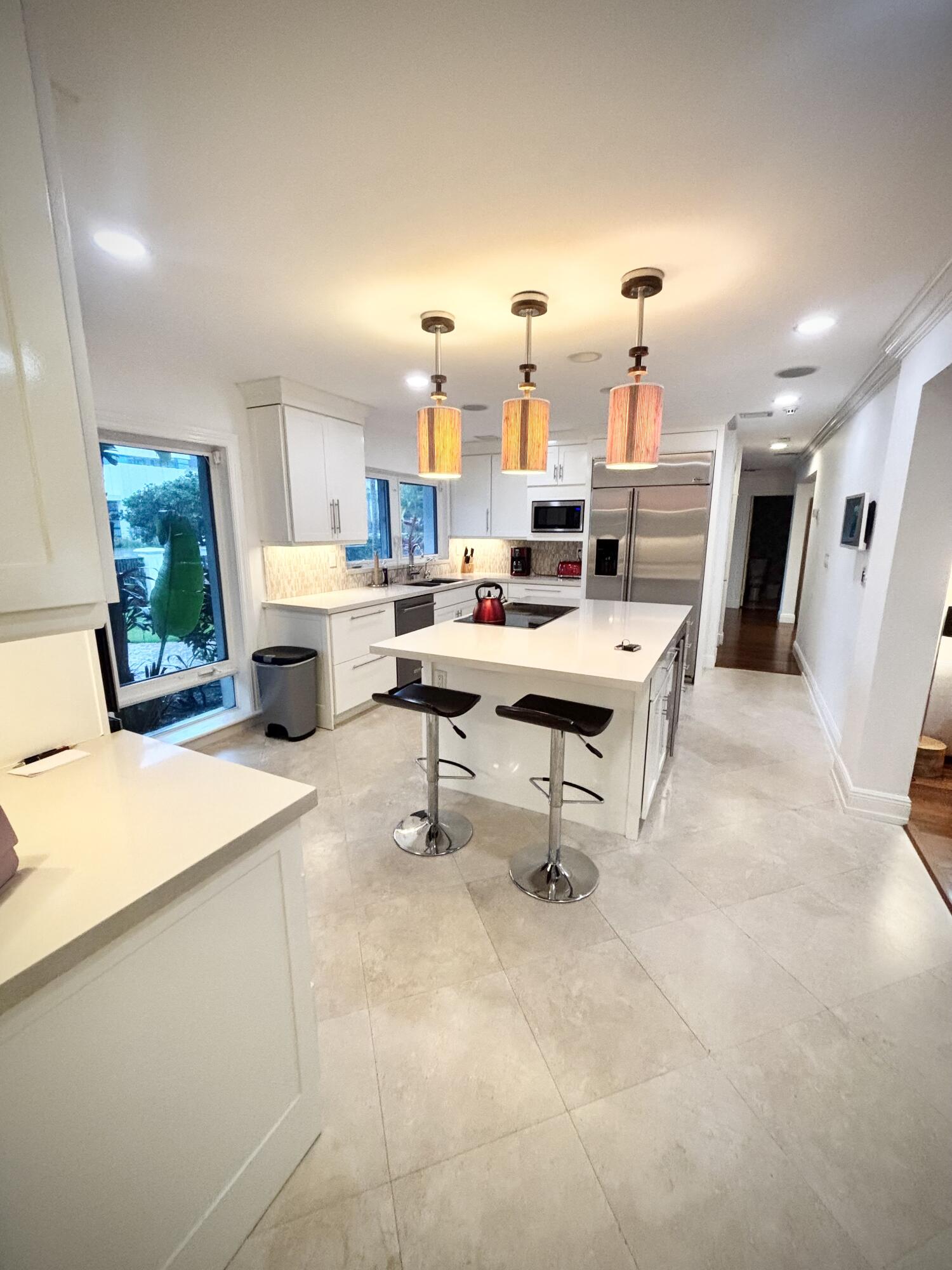 2100 Spanish River Road Boca Raton, FL 33432 - Photo 37 of 38 a room with stainless steel appliances furniture a rug and a view of kitchen