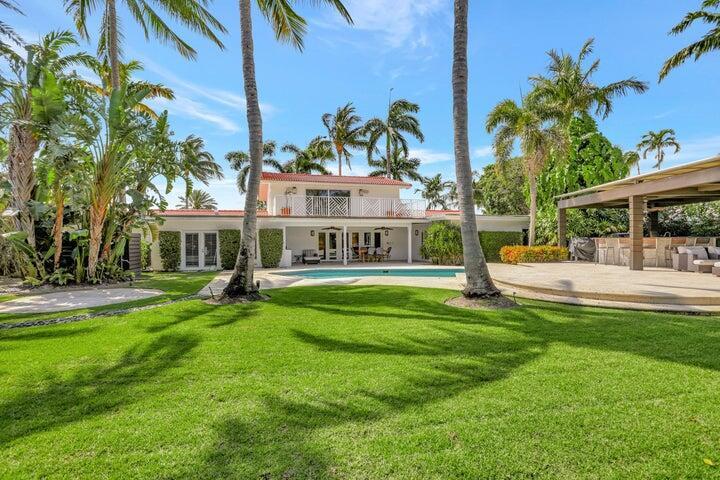 2100 Spanish River Road Boca Raton, FL 33432 - Photo 9 of 38 a view of a house with swimming pool and a bench