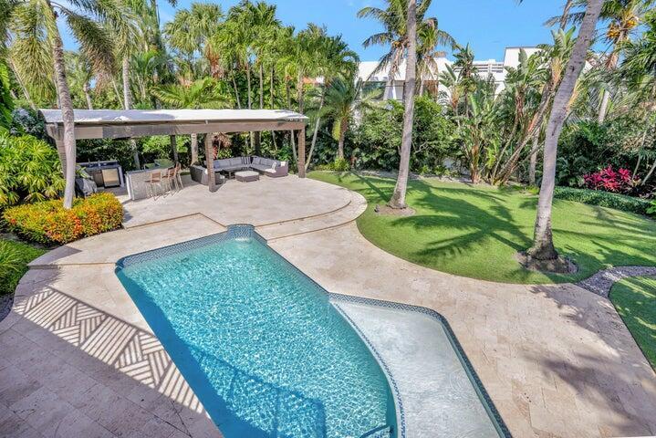 2100 Spanish River Road Boca Raton, FL 33432 - Photo 10 of 38 swimming pool view with a seating space and a garden view