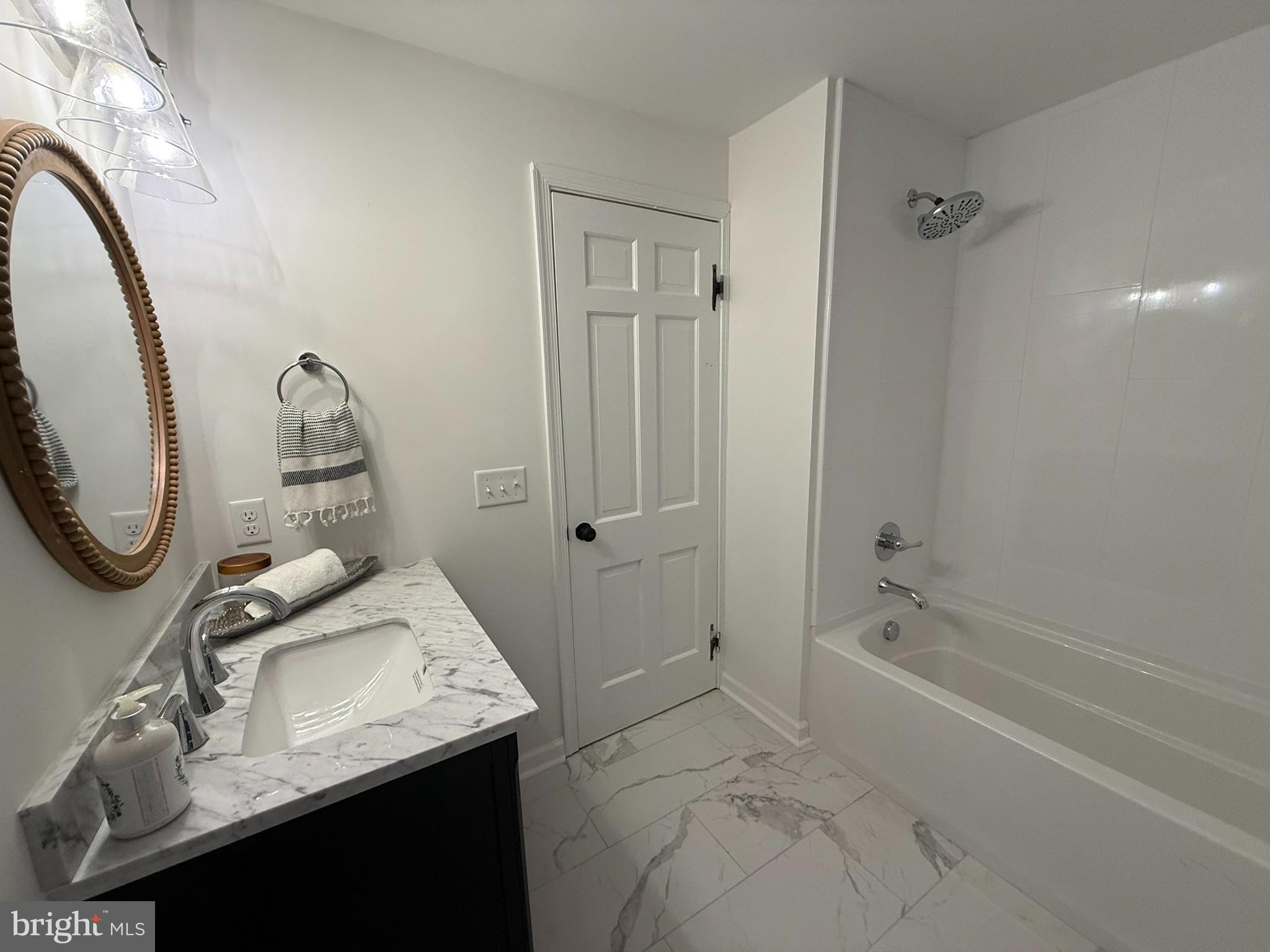 530 Woodsedge Road Dover, DE 19904 - Photo 44 of 52 a bathroom with a granite countertop sink a mirror and shower