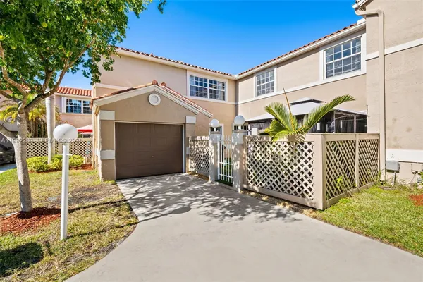 a front view of a house with parking area