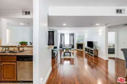 a view of a living room kitchen and a wooden floor