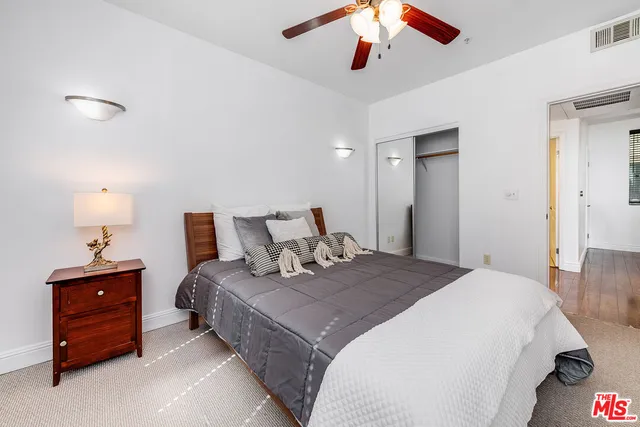 a bedroom with a bed and a lamp