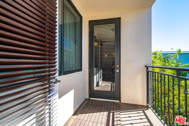 a view of a balcony with wooden floor