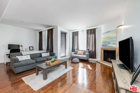 a living room with fireplace furniture and a flat screen tv