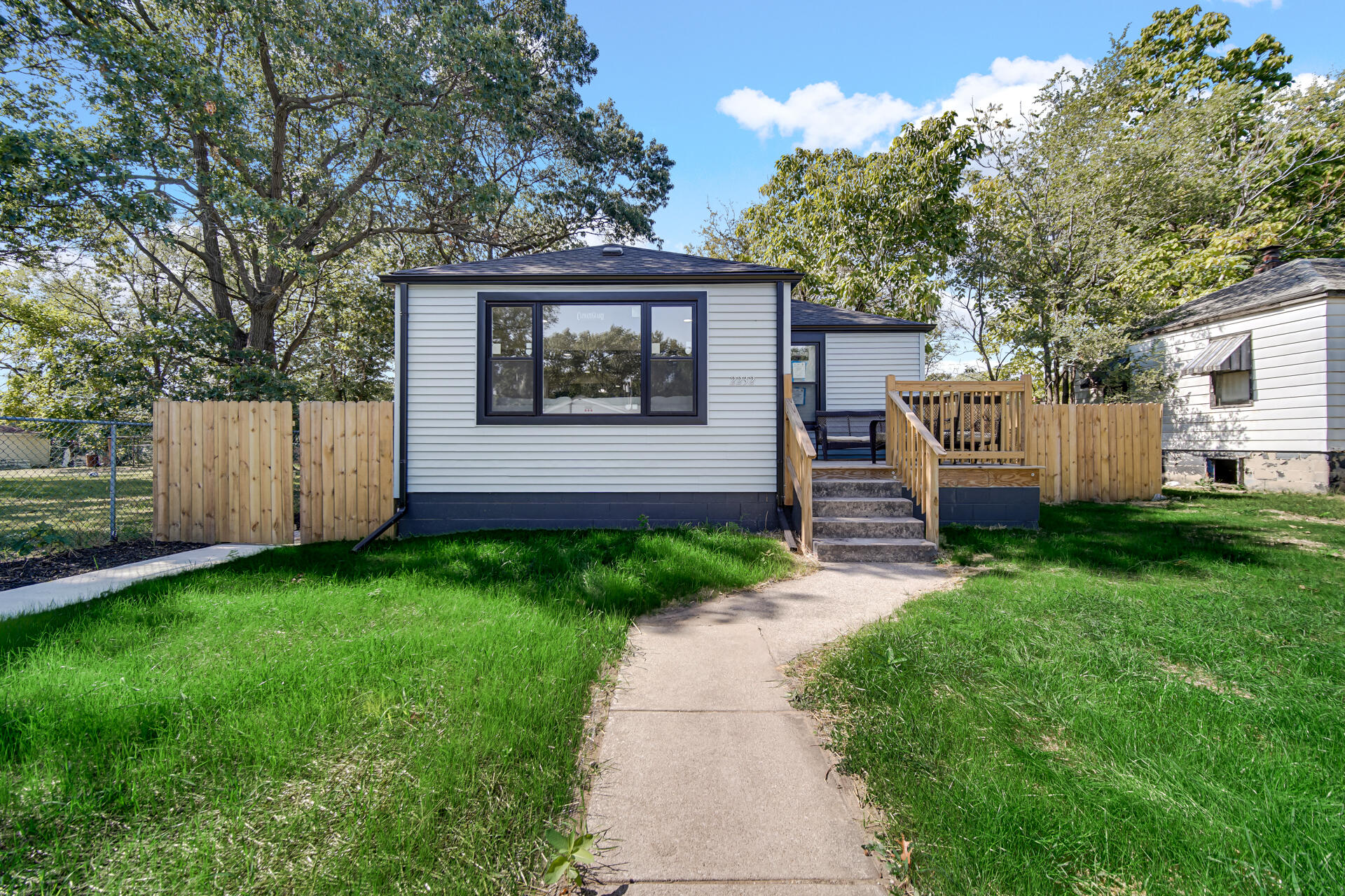 2232 Roosevelt Place Gary, IN 46404 - Photo 2 of 21 a view of a house with a small yard and a large tree