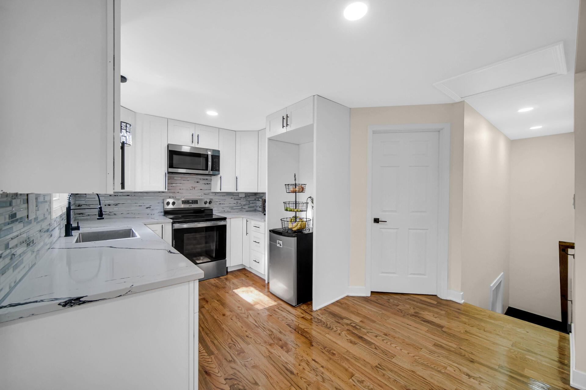 2232 Roosevelt Place Gary, IN 46404 - Photo 6 of 21 a kitchen with granite countertop a stove a sink and a refrigerator