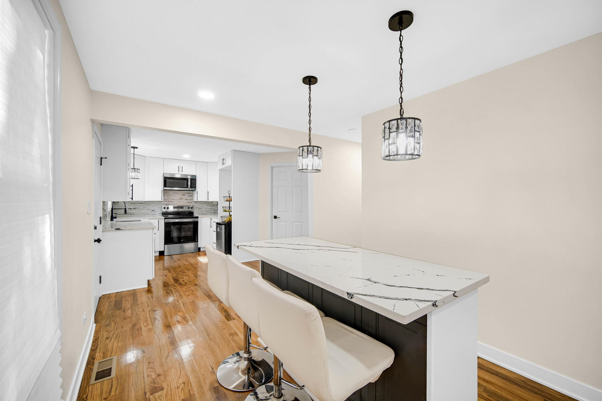 2232 Roosevelt Place Gary, IN 46404 - Photo 7 of 21 a kitchen with stainless steel appliances kitchen island granite countertop a stove a sink and a refrigerator