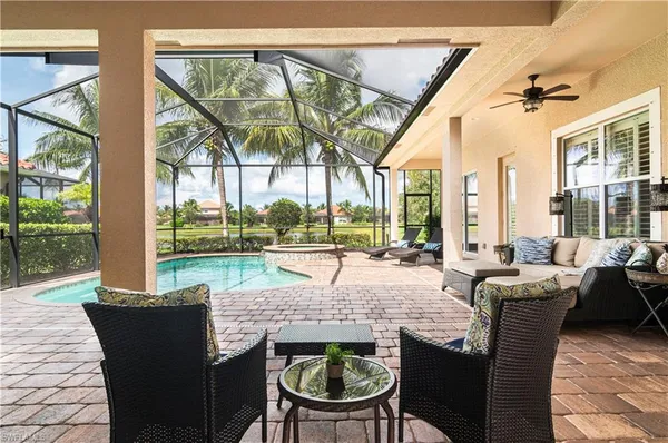 a view of an outdoor dining space with a table and chairs