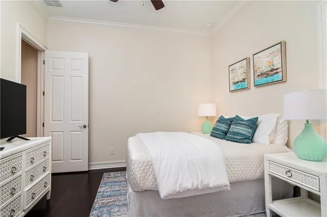 a bedroom with a bed and a flat tv screen on the dresser