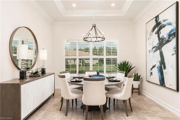 a dining room with furniture and a window