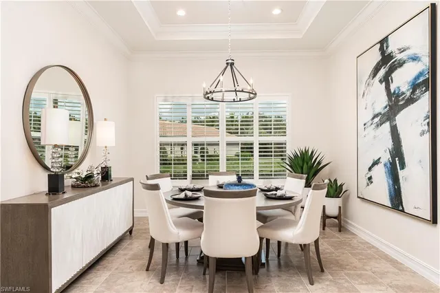 a dining room with furniture and a window