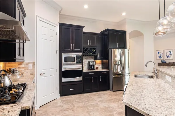 a kitchen with stainless steel appliances granite countertop a refrigerator stove and oven