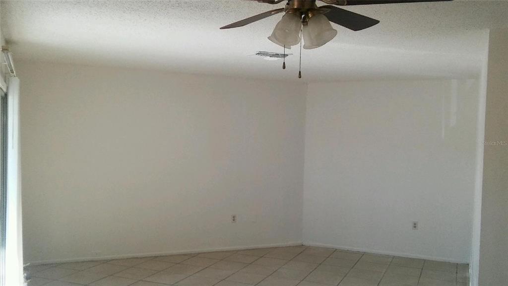 3648 Meriden Avenue Oldsmar, FL 34677 - Photo 2 of 5 a view of a room with a ceiling fan and a fan