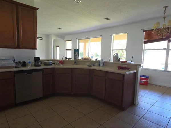 a kitchen with a sink a window and cabinets