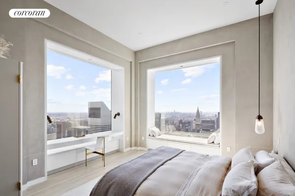 a bedroom with a large bed and a large window