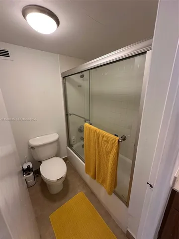 a bathroom with a glass shower door