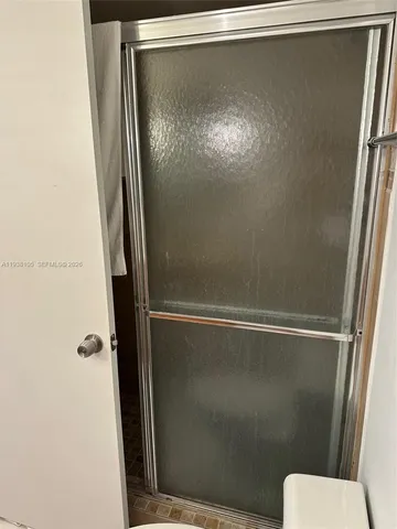 a view of walk in closet with clothes