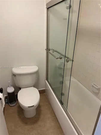 a bathroom with a glass door shower
