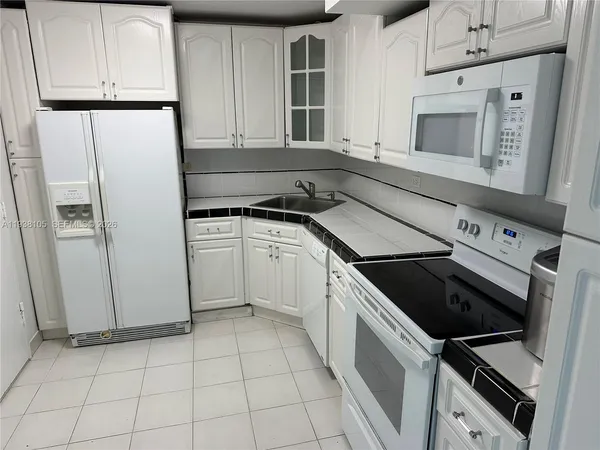 a view of a kitchen with dishwasher and refrigerator
