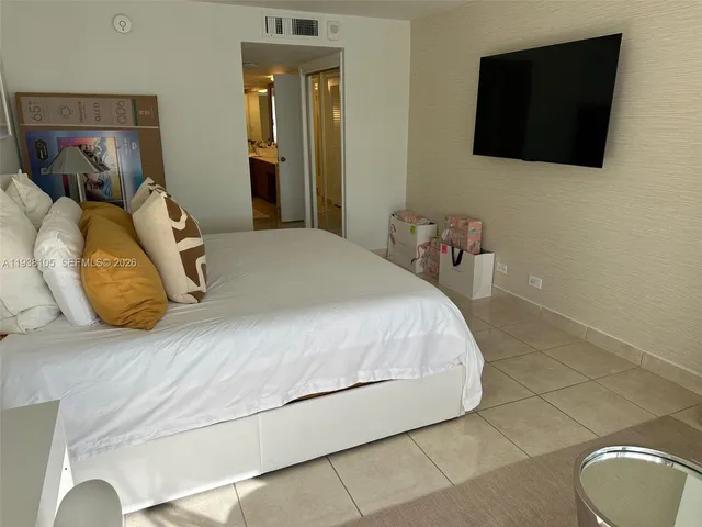 a bedroom with a bed and a couch