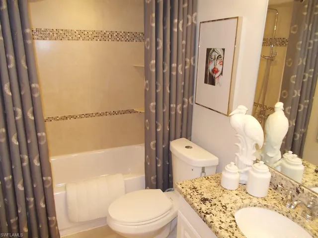 a white toilet sitting next to a bathroom sink