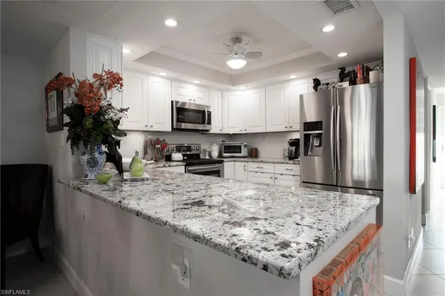 a kitchen with kitchen island granite countertop counter top space cabinets and stainless steel appliances