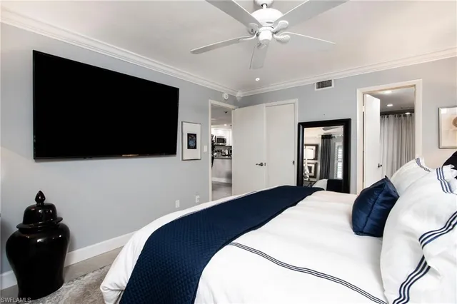 a bedroom with a bed tv and a fireplace