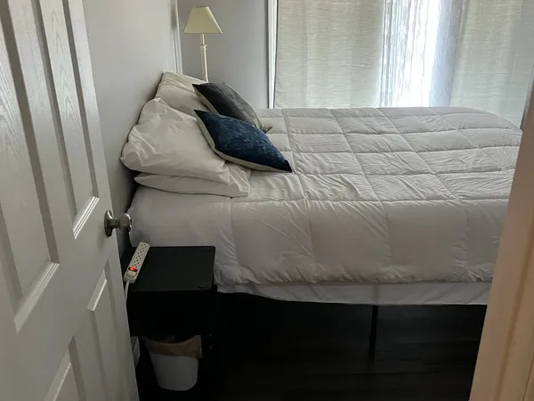 a bedroom with a bed and a television