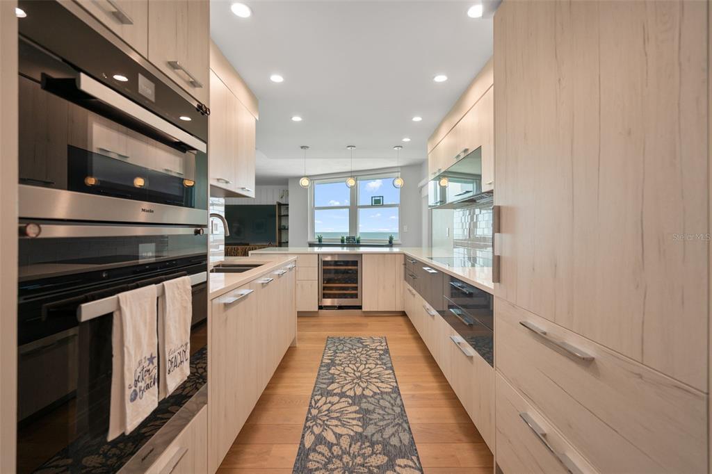 1050 Longboat Club Road, Unit 901 Longboat Key, FL 34228 - Photo 9 of 37 a large white kitchen with stainless steel appliances