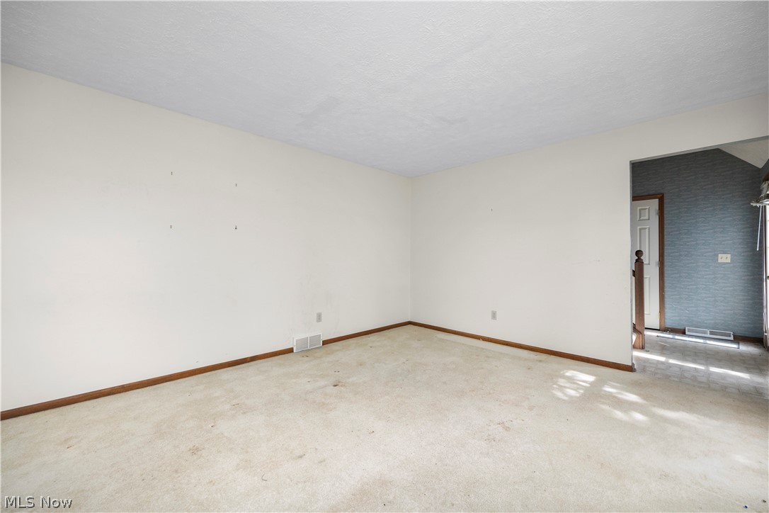 722 Jaycox Road Avon Lake, OH 44012 - Photo 15 of 48 Spacious room featuring light-toned carpeting and neutral walls, with hardwood-finish baseboards