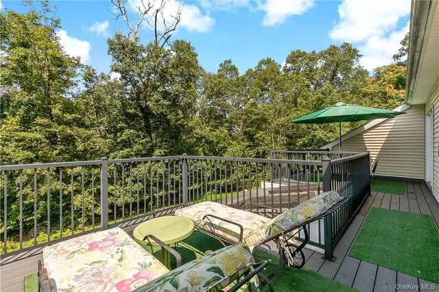 a balcony with table and chairs