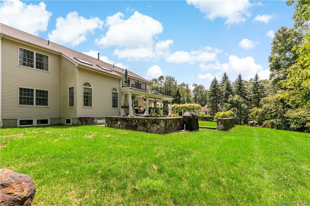 4 Sonoma Road Cortlandt Manor, NY 10567 - Photo 30 of 31 a view of a house with backyard sitting area and garden