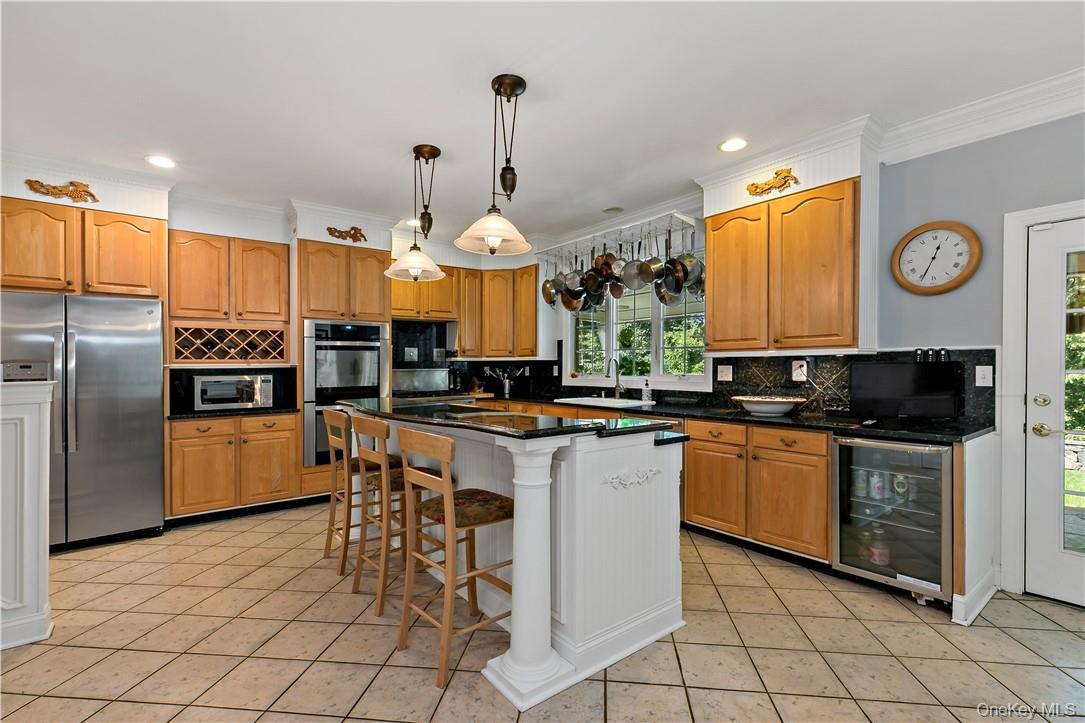 4 Sonoma Road Cortlandt Manor, NY 10567 - Photo 9 of 31 a kitchen with stainless steel appliances a stove a sink a oven a table and chairs