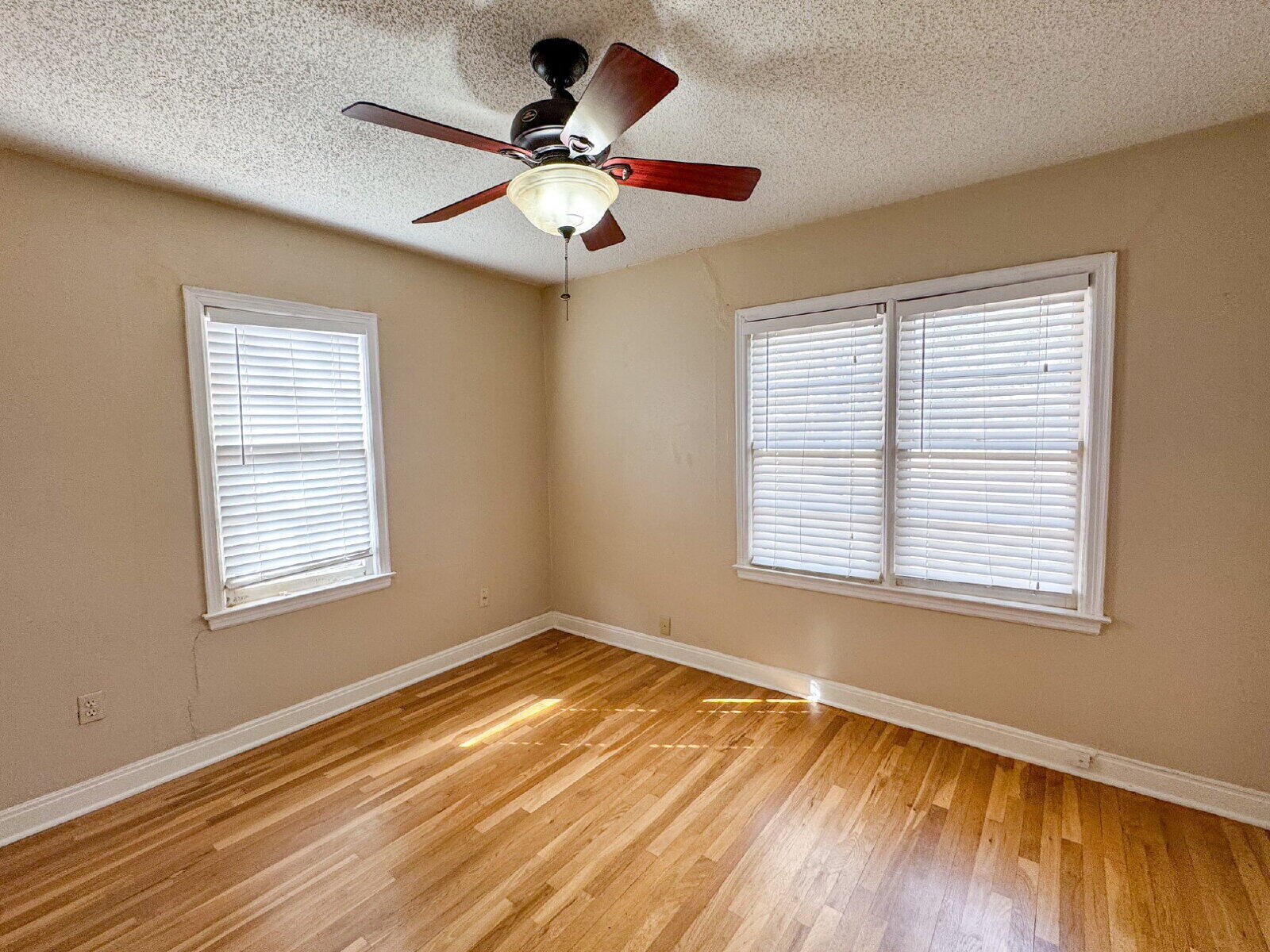 2909 Canton Avenue Lubbock, TX 79410 - Photo 15 of 18 a view of an empty room with wooden floor and a window