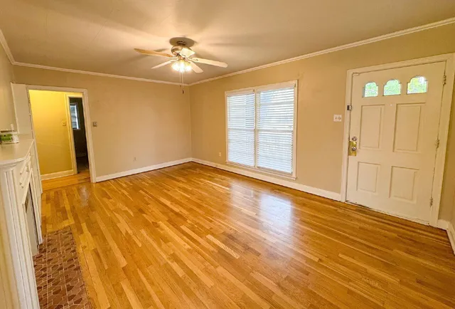 wooden floor in an empty room with a window