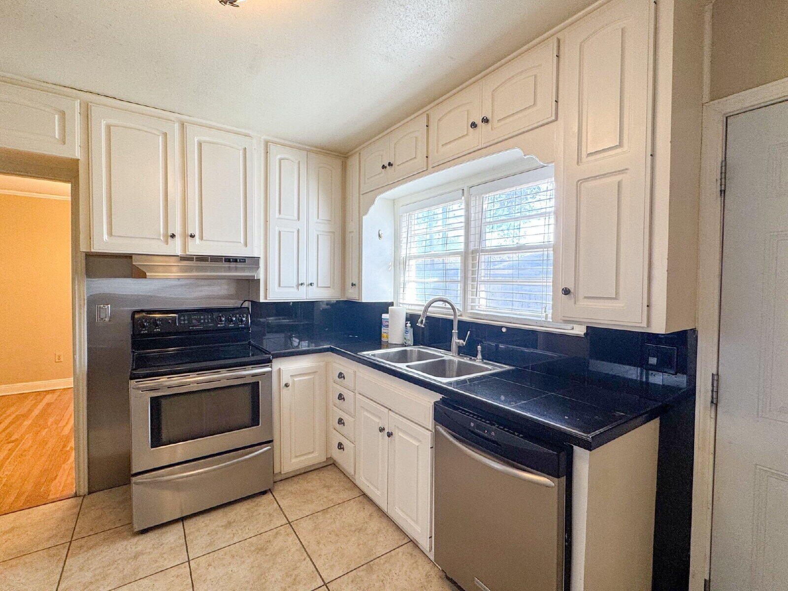 2909 Canton Avenue Lubbock, TX 79410 - Photo 8 of 18 a kitchen with stainless steel appliances granite countertop a sink stove and cabinets