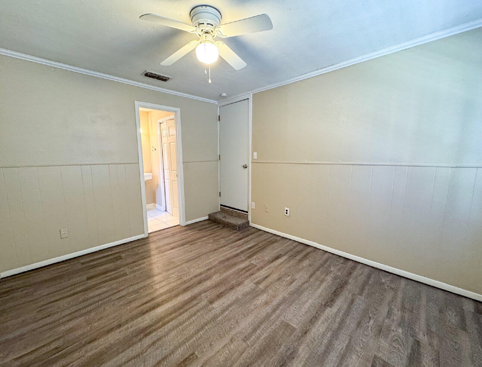 2909 Canton Avenue Lubbock, TX 79410 - Photo 10 of 18 an empty room with wooden floor and windows