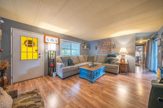 a living room with furniture and a wooden floor