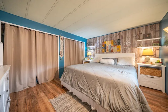 a bedroom with a large bed and a large window