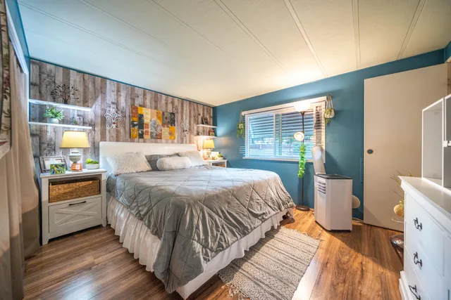 a bedroom with a bed and a large window