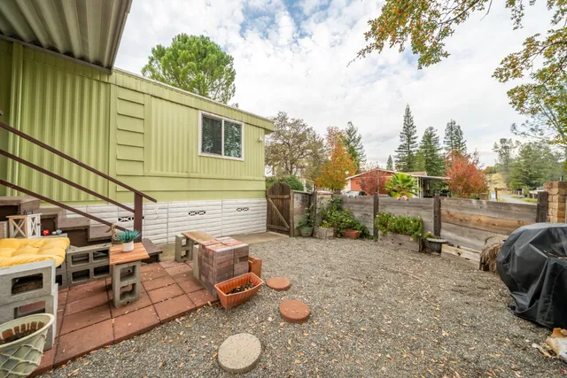 a view of backyard with barn and a large tree