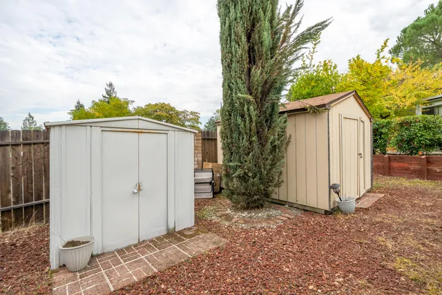 a backyard of a house with yard and outdoor seating